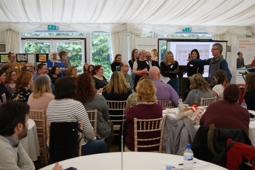 Group of people listening to a guest speaker