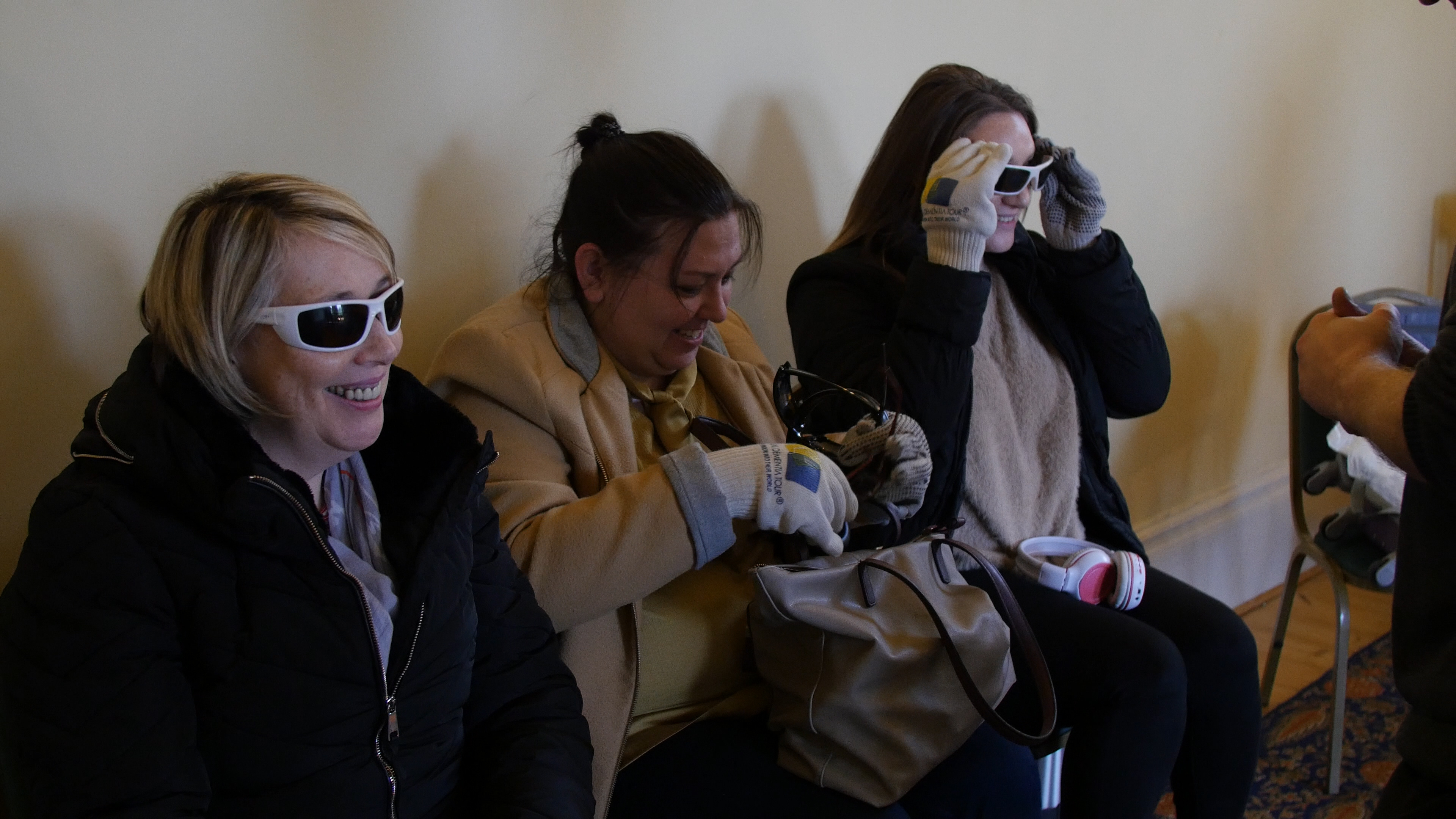 Three women getting ready for a dementia experience